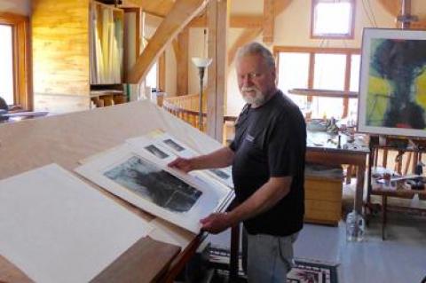 Dan Welden examined a portfolio of Solarplate prints in his mezzanine studio in Noyac.