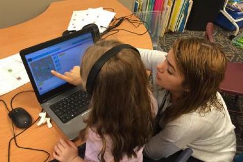 Kembly Berrocal, right, a teaching assistant at the Wainscott School, helped a young student with a coding activity during a technology lesson.