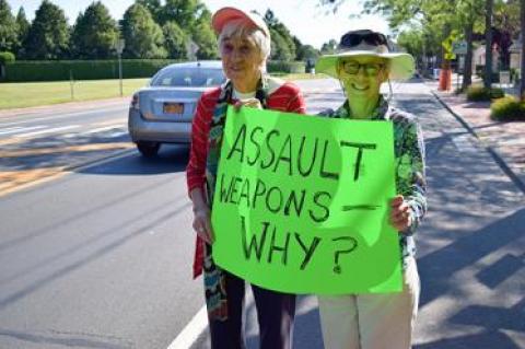 Nicki Mazur, right, and Arlene Coulter were among the dozen at a rally along Montauk Highway in Water Mill to ban assault weapons. The East Hampton and Southampton Town Democrats were the sponsors.