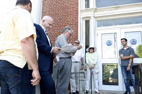 After a few tense moments on the steps of Southampton Town Hall, Mitch Winston, right, was ultimately the winning bidder at the auction of the old Morpurgo house in Sag Harbor Village.