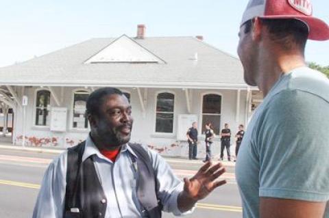 While East Hampton Village police stood guard at the East Hampton train station Sunday morning, Shelwyn Hendy, a Long Island Rail Road conductor talked to Teddy Montalvo, a passenger evacuated from the train after the Metropolitan Transportation Authority received a bomb threat.