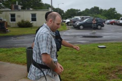 Timothy M. Egan, shown here before his arraignment last Thursday, has been charged with assault after allegedly punching a man hard enough to cause bleeding on the brain.