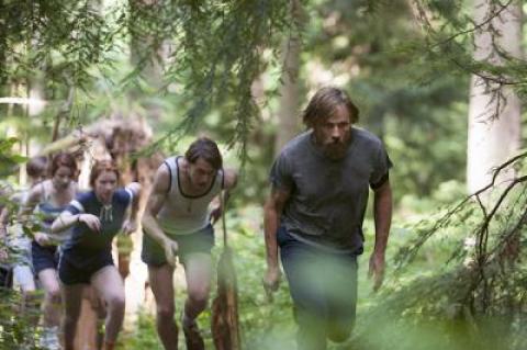 Ben Cash (Viggo Mortensen) leads his children in a forced march through the woods as part of their survival training in “Captain Fantastic.” Below, his character enjoyed a quiet moment with his daughter on the steps of their cabin.