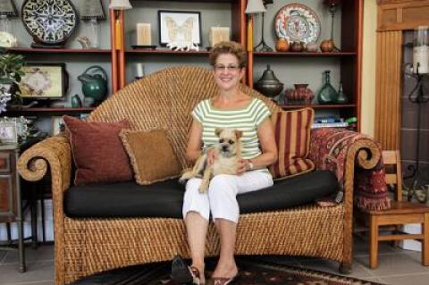 Marcia Previti, whose garden is a series of rooms enlivened by her architectural background and sculptures, below, sat at home with her dog, Dallas, on a recent afternoon.