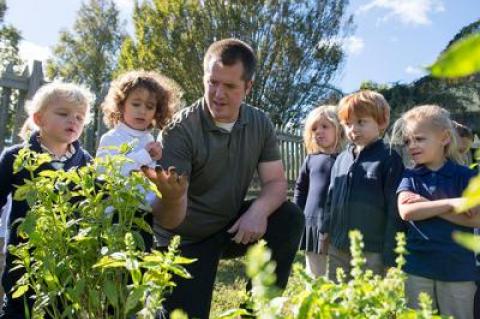 Bryan Smith, center, a Ross School science teacher, often leads lessons outdoors on the Lower School campus, which has recently been certified as a wildlife habitat by the National Wildlife Federation.