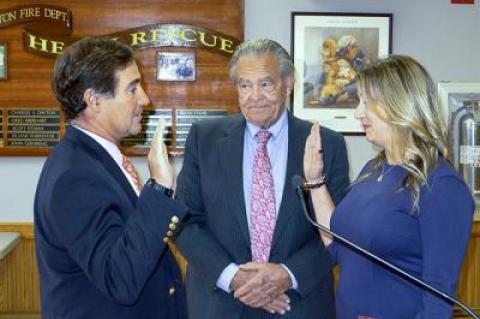 Philip O’Connell, left, was sworn in as the newest member of the East Hampton Village Board by Rebecca Molinaro, the village administrator, as Mayor Paul F. Rickenbach Jr. looked on.