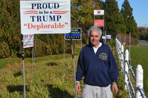 “I think Trump is going to surprise you. You have to give him a chance,” said Andy Sabin of Amagansett, posing near his collection of Trump lawn signs.