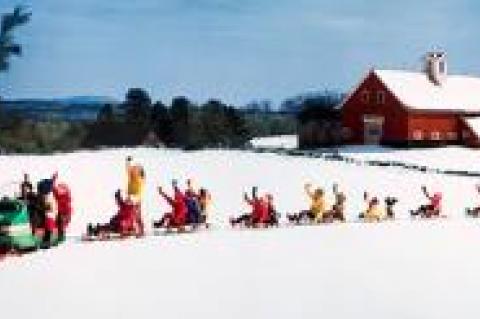 The photographer Ozzie Sweet depicted a bucolic New Hampshire winter in “Snowmobile Pulling 9 Sleds.”