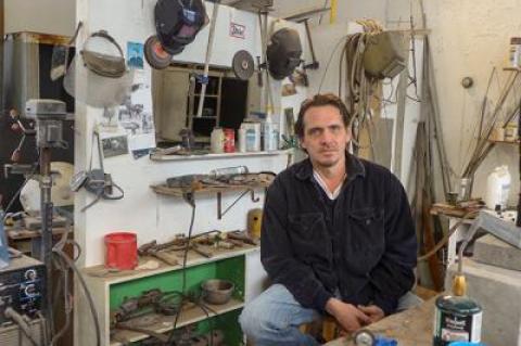 Paul Pavia surrounded by the many tools of his trade in his Springs studio. Below, “Morat Coil,” 2016, bronze, wood, and  marble