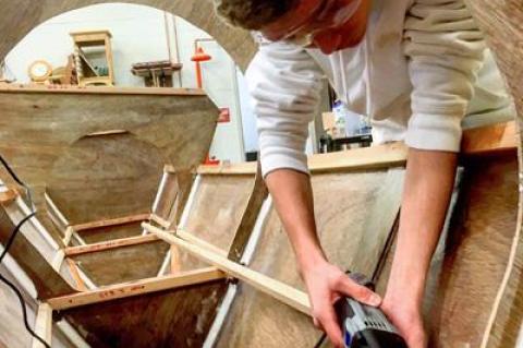 Henry Saar, a student in one of Andy Rigby’s woodworking classes at East Hampton High School, worked on the catamaran students are building under the guidance of the Montauk Catamaran Company.