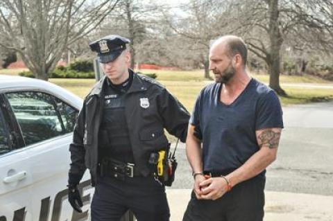 Jefferson Davis Eames was led into East Hampton Town Justice Court on Friday for his arraignment on multiple charges stemming from alleged under-age parties at his house.