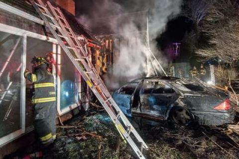 A burned-out shell was all that remained of the Mercedes that crashed through a fence before slamming into a house on Hayground Road in Water Mill early Sunday morning. The house was badly damaged by fire.