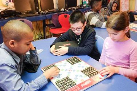 How many words can you make from 25 random tiles? Mikhail Feaster, left, Carlos Carmona, center, and Jasmin DelGiorno ponder the challenge at the Bridgehampton Child Care and Recreation Center.