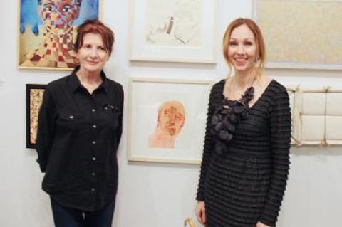 Joyce Kubat, left, winner of top honors, and Andrea Grover, Guild Hall’s executive director, flanked “Armour,” Ms. Kubat’s winning entry.