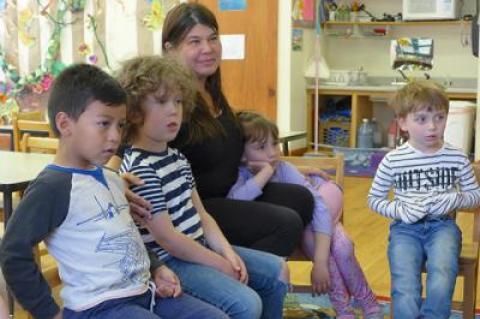 The Country School in Wainscott, founded by Deena Zenger, seen here sitting with students, received an eviction notice from East Hampton Town this week.