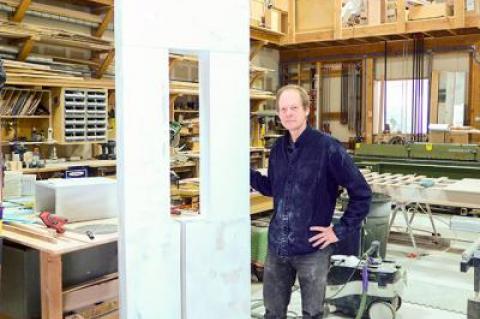 Mark Webber’s work in progress, seen here in his woodworking studio in Wainscott, is the largest of his signature “portals.”