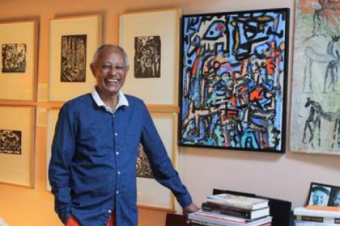 E.T. Williams Jr. was flanked by a suite of woodcuts by Hale Woodruff and a colorful abstract painting by Claude Lawrence.