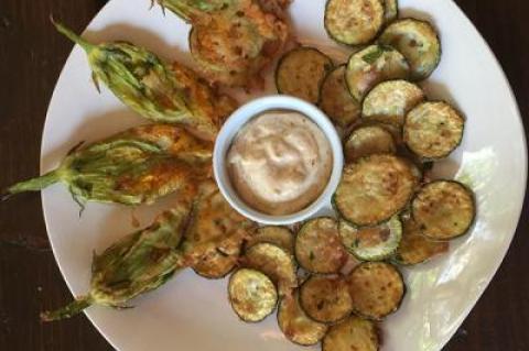 It’s not too early for locally grown zucchini blossoms, at least from the greenhouse. Peanut oil can take the heat required for high-temperature frying without burning.