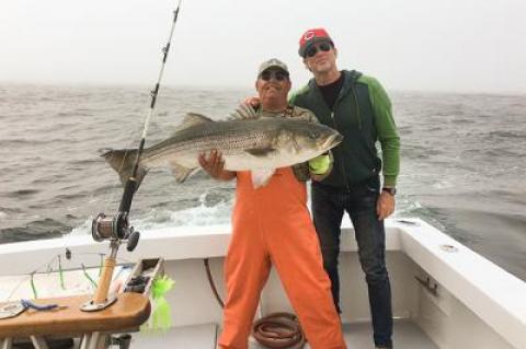 Chad Smith, right, the drummer for the Red Hot Chili Peppers, caught this 41-pound striped bass earlier this month on the Breakaway out of Montauk. With him is the first mate, Eddie Harrison. A picture that ran in this spot last week incorrectly identified the man with a fluke as Mr. Harrison.