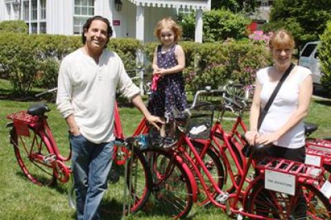 Jonathan Baker and Jenny Ljungberg got ready for a bicycle ride with Maddie, their daughter, outside the Maidstone Hotel in East Hampton, which they own.