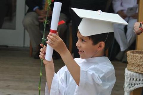 Clad in caps and “gowns,” prekindergartners graduating from the Eleanor Whitmore Early Childhood Center on Friday morning got a diploma and a red carnation.