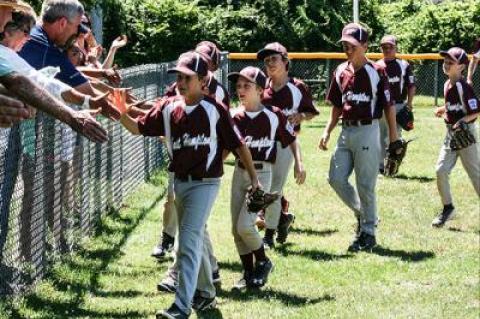 Atta boy: East Hampton’s 9-10 Little Leaguers were congratulated by their parents after Sunday’s 13-4 win here over Patchogue-Medford. On Monday, in Riverhead, they won the District 36 championship.