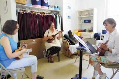 Barbara Raeder, center, with students at her first ukulele class, held at the East Hampton Presbyterian Church on Tuesday.