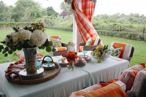 The covered porch at the house at 78 Rosko Lane in Southampton, also referred to as Linden, was designed by Lisa Mende with a pop of orange.