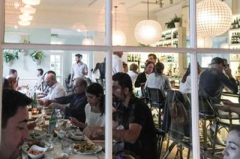 A window view of the dining room and bar at Wolffer Kitchen’s latest venue, in Amagansett