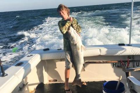 Bennett Burki, 14, caught a 35-pound striped bass on the charter boat Hurry Up off Montauk on Monday. 	Peter Burki