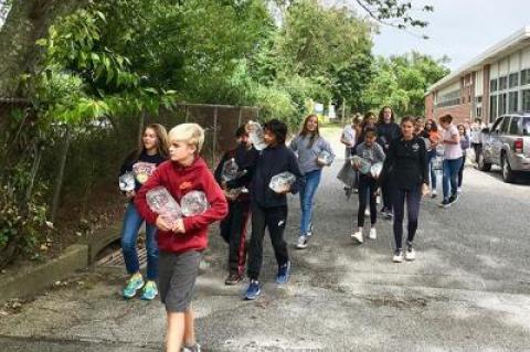 Learning by doing, East Hampton’s seventh graders experienced the arduous task of carrying water from the middle school to the high school and back, which tied in to the subject of a book they are reading in class as well as a film project they are working on in conjunction with the Hamptons International Film Festival.