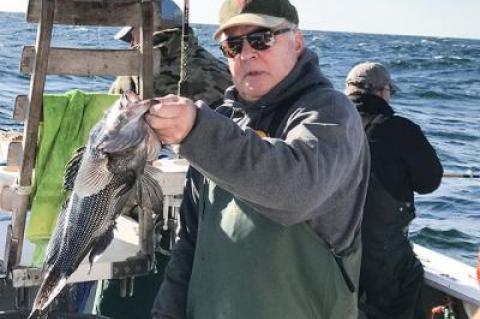 Tim Mott of Sag Harbor held a sea bass taken on Friday aboard the Oh Brother out of Montauk.