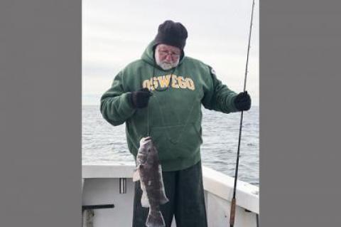 Al Daniels held a six-pound blackfish taken at Fishers Island on Sunday.