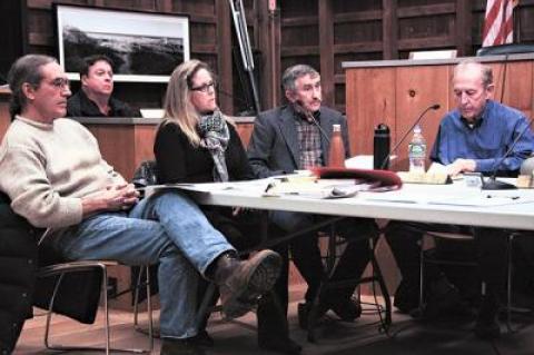 While new East Hampton Town Trustees, including, at right, John Aldred and Susan Vorpahl, sat down for their first meeting, the board’s attorney, Richard Whalen, in the background, announced he would step down.