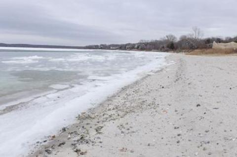 Havens Beach in Sag Harbor was on the receiving end of a harbor dredging project in the fall that left gray silt and more rocks than usual on the sand. Village officials have said they will remove as many of the rocks as possible.