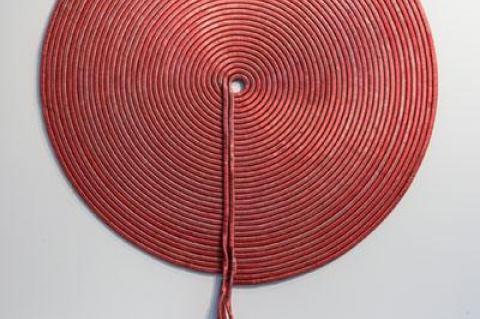 A wall piece by Alice Hope, above, that resembles a coil of rope is actually constructed from dyed soda can tabs and tubing. The black-and-white organic forms in Hiroyuki Hamada’s large-scale prints, below, are similar to those found in his three-dimensional work.