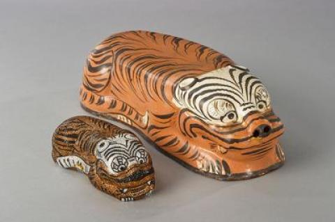 Objects from the Leibers’ collection of Chinese ceramics include a tiger-form pillow with tiger handbag.