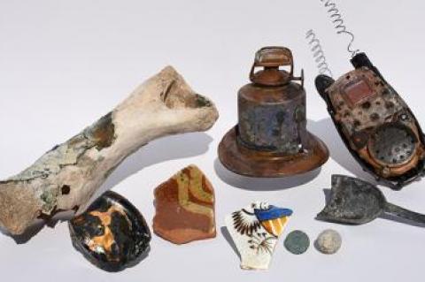 The pieces of history that turned up on Havens Beach included a musket ball, an oil lamp, and a coin minted in 1875.