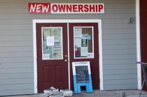 “Due to owner disagreements Hampton Beverage East was forced to close on July 31,” reads a sign on the door of the Pantigo Place, East Hampton, business. The building, which is shared by Goldberg’s Bagels, is for sale.