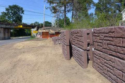 Construction of the retaining walls under the village’s railroad trestles will include the installation of concrete blocks.