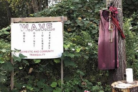 A red dress, a symbol of the plight of missing and murdered indigenous women and organized efforts to fight Native American women’s heightened risk of violence, hangs near the Peace Fire site on the Shinnecock Reservation in Southampton.