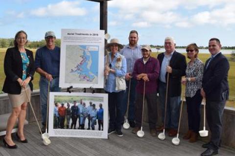 Suffolk County Legislator Bridget Fleming, left, with county, East Hampton Town, and Nature Conservancy officials celebrated a trial program that saw a large reduction in the use of methoprene to control mosquitoes at Accabonac Harbor.