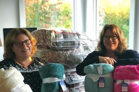 Nina Landi, left, and Daisy Dohanos with some of the blankets they are collecting for hospice patients