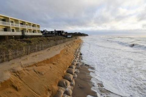 On Sunday, waves lapped at the downtown Montauk oceanfront, where erosion from recent storms has carried away sand and exposed the sandbags beneath it. A Montauk hamlet study recommends coastal retreat for oceanfront motels and a gradual shift to higher ground.