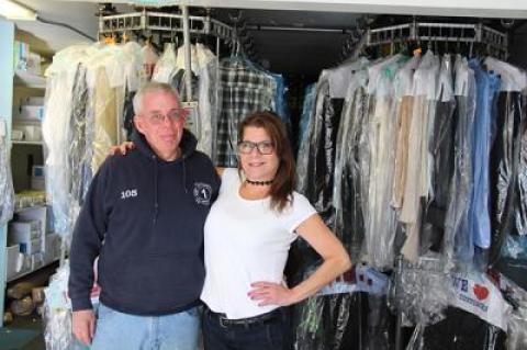 Eddie Downes, left, a presser at East Hampton Cleaners for 30 years, and Grace LaBarbera, who has worked there for six years, are the only two employees remaining as the shop prepares to close at the end of the month.