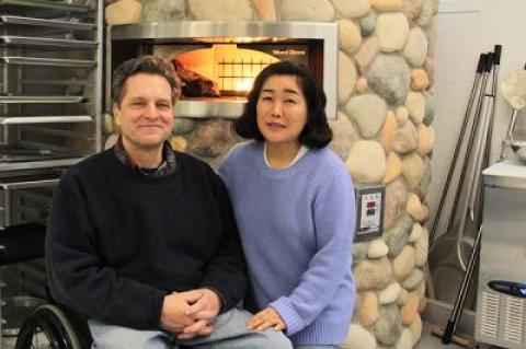 Bruce Damark and Michiko Damark in front of the wood-fired oven in their new and improved 11,000-square-foot Damark’s Deli on Three Mile Harbor Road in East Hampton.