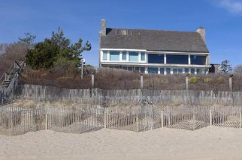 The owners of a beachfront Lily Pond Lane property in a coastal erosion hazard area want to tear down this house and build a new one in its place.