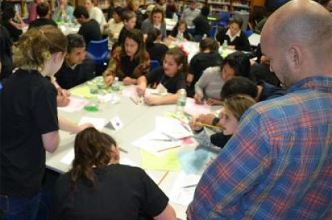 A parent looked on as Springs School sixth graders and families created cultural handprints at the 2018 Diversity Institute.