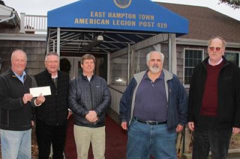 Bill Mott, commander of the East Hampton American Legion Post, left, accepted a $5,400 check Monday from John McGuirk of Dayton, Ritz and Osborne Insurance for a 9/11 memorial to be built at the legion property in Amagansett. Also pictured are Fred Ritz, Tony Ganga of the Sons of the American Legion, and George Yates, also of the insurance firm.