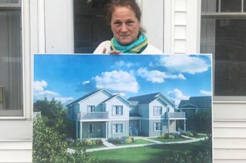 Catherine Casey, the executive director of the East Hampton Housing Authority, displayed a photo of the modular buildings to be constructed for affordable housing in Amagansett.